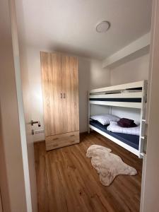 a bedroom with a bunk bed and a wooden floor at Apartment Ana in Arzl im Pitztal