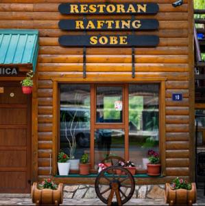 a store front with a sign for the restroom at Rafting Blue River Tara in &Scaron;ćepan-Polje
