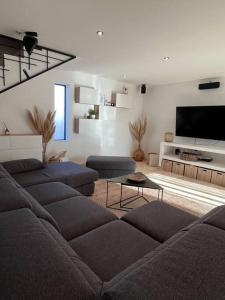 a living room with a couch and a flat screen tv at Villa Paradou in Paradou