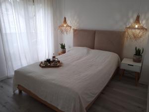 a bedroom with a bed with a tray of food on it at Baltic Nature in Łukęcin