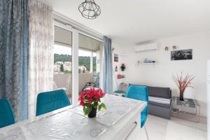 a living room with a table and blue chairs at Frana Blue apartment in Split