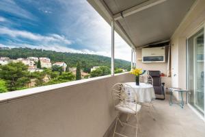 a balcony with a table and chairs and a view at Frana Blue apartment in Split