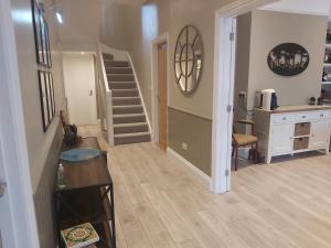 a living room with a staircase and a table at Bay House in Totland