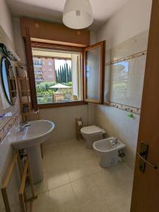 a bathroom with a sink and a toilet and a window at Residenza Alabama in Rome