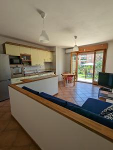 a kitchen with a couch in the middle of a room at Residenza Alabama in Rome