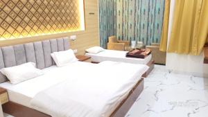 A bed or beds in a room at RBS Hotel & Restaurant 5 mint walking distance from Ram Janam Bhumi