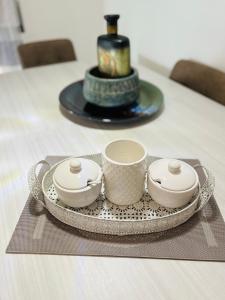 a table with a plate with two cups on it at Giada Apartment in Verona