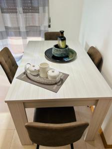 a wooden table with cups and plates on it at Giada Apartment in Verona