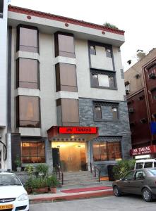 a building on a city street with cars parked in front at Inn Tawang Near B L Kapoor Hospital A Well Hygiene Hotel in New Delhi