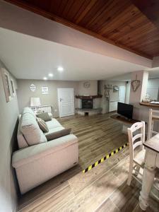 a living room with a couch and a table at Al Cottage in Oliveto Lario