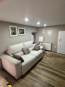 a living room with a white couch and a table at Al Cottage in Oliveto Lario