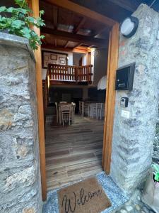a door leading to a dining room with a table at Al Cottage in Oliveto Lario