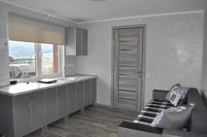 a kitchen with a couch and a table in a room at Кукул in Vorokhta +8 photos