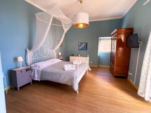a bedroom with a bed with a canopy at Mid Modern Akragas Home in Center with Sea View in Agrigento