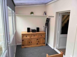 a room with a wooden cabinet and a door at Fisherman Cottage Morecambe in Morecambe