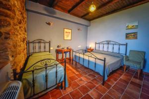 a bedroom with two beds and two chairs at Tenuta TerraRossa in Rossano