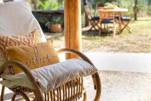 a rocking chair with a pillow on a porch at SARDINIA RE - Casa Luisa With Pool in Alghero
