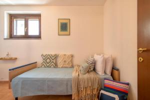 A bed or beds in a room at SARDINIA RE - Casa Luisa With Pool