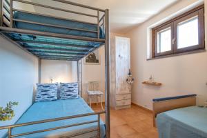 A bed or beds in a room at SARDINIA RE - Casa Luisa With Pool