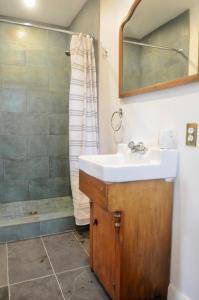 a bathroom with a sink and a shower at Napier House in Campbellton