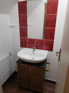 a bathroom with a sink and a mirror at Le manège Gite Le phare in Sainte-Marie-au-Bosc