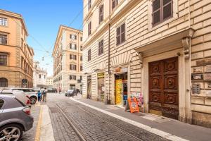 a street with buildings and cars parked on the street at DM69 - Termini Monti Crossroads in Rome