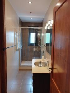 a bathroom with a sink and a shower at CAL JAN - CADÍ in Bellver de Cerdanya 
