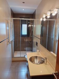 a bathroom with a sink and a shower at CAL JAN - CADÍ in Bellver de Cerdanya 