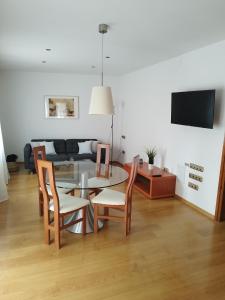 a living room with a table and chairs and a couch at CAL JAN - CADÍ in Bellver de Cerdanya 