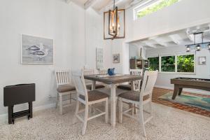 a dining room with a table and chairs and a piano at Florida Seaside Get Away- 50 Steps to Beach in Boynton Beach