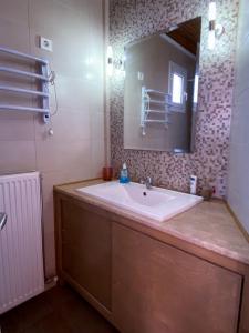a bathroom with a large sink and a mirror at Mia's Home in Kalamata +32 photos