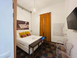 a room with a bed and a table and a tv at La Vaticana in Rome