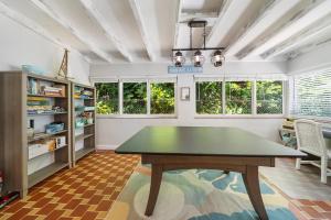 a dining room with a table and some windows at Florida Seaside Get Away- 50 Steps to Beach in Boynton Beach