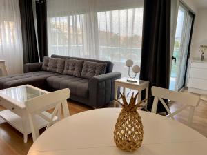 salon z kanapą i ananasem na stole w obiekcie VoraMar 3 Playa Puerto de Sagunto w mieście Sagunto