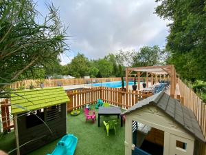 a backyard with a playground with a pool at Camping la Venise Verte in Coulon