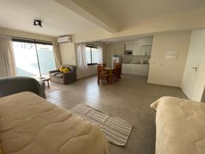 a bedroom with a bed and a kitchen and a living room at Excepcional apartamento, con patio cochera y parrilla en el centro in La Cieneguita +13 photos