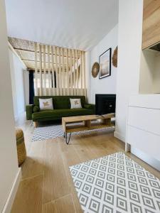 - un salon avec un canapé vert et une table dans l'établissement Casa Albufera suite, à Valence