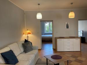 a living room with a couch and a table at Apartament Turkus in Gdynia