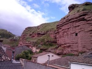 a large mountain with houses in front of it at Hostal Ciudad de Nájera in Nájera