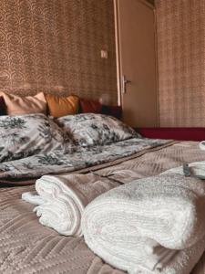 a bed with two towels on top of it at Milkyway Apartment in Viareggio