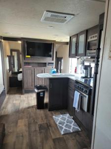 an rv kitchen with a sink and a stove at Beach and Bay Glamping in Bolivar Peninsula