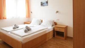 Postel nebo postele na pokoji v ubytování Tomic Apartments