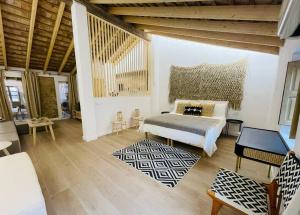 a bedroom with a bed and a room with a table at Loft Albufera in Valencia