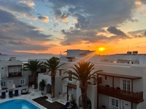 a view of a building with a sunset in the background at Georgia Mare in Naxos Chora