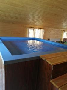 a pool of water in a room with a table at Cabana Diana&Larisa in Arieşeni