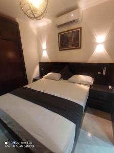 a bedroom with a large bed with two pillows at شاليه سي فيو بورتو مارينا - Porto Marina Sea View in El Alamein