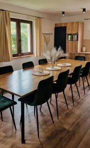 a conference room with a large wooden table and chairs at Apartamenty U Pana Jana in Wetlina