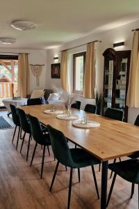 a large wooden table and chairs in a living room at Apartamenty U Pana Jana in Wetlina