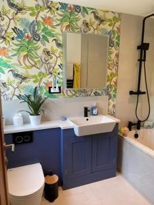 a bathroom with a sink and a toilet and a tub at Luxury Devon House in Chulmleigh