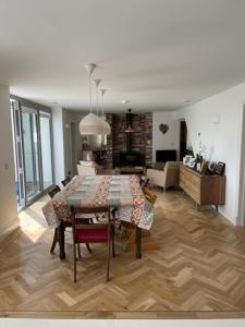 a living room with a dining room table and a kitchen at Luxury Devon House in Chulmleigh